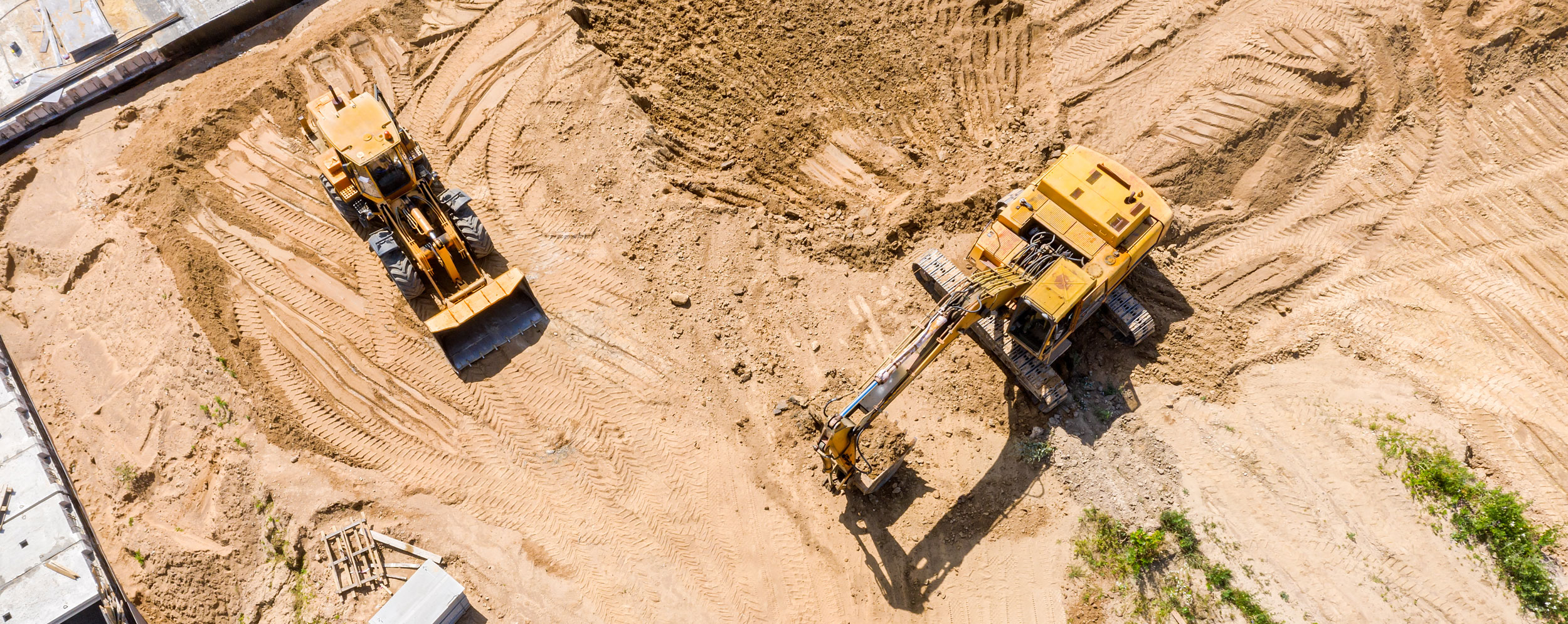 Construction vehicles excavating a site